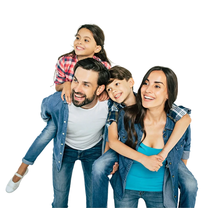 Family of four, two adults and two children. Smiling and looking happy.