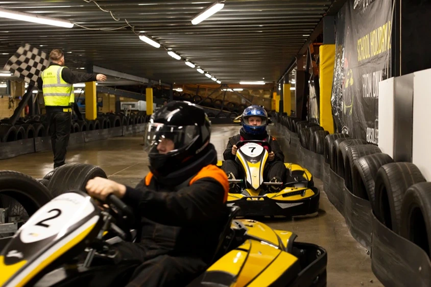 Young racers getting instructed by staff to pull over in the lane after the race